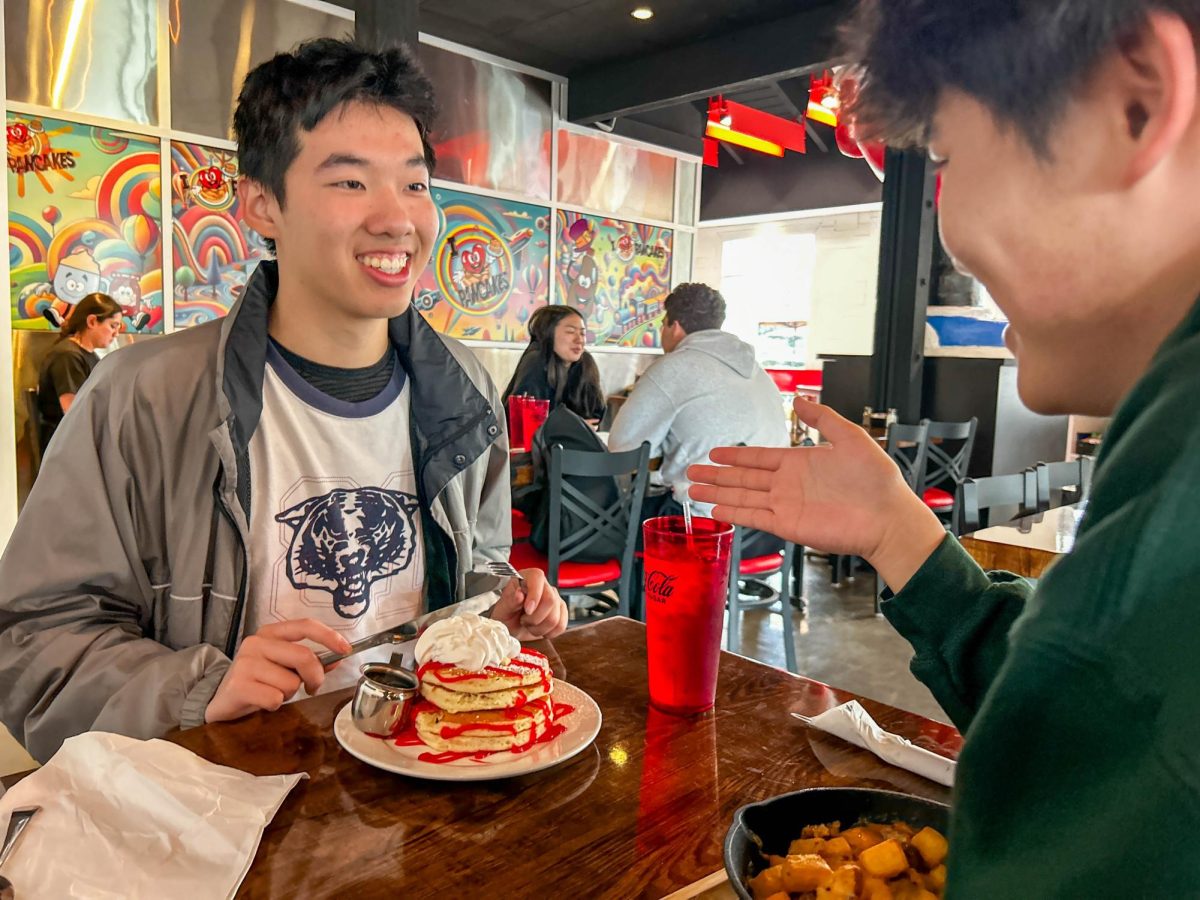 STACK IT UP: Senior Jonathan Zhu dives into a fresh, fluffy heap of strawberry-flavored I Heart Cheesecake Pancakes while spending quality time with his best friends.