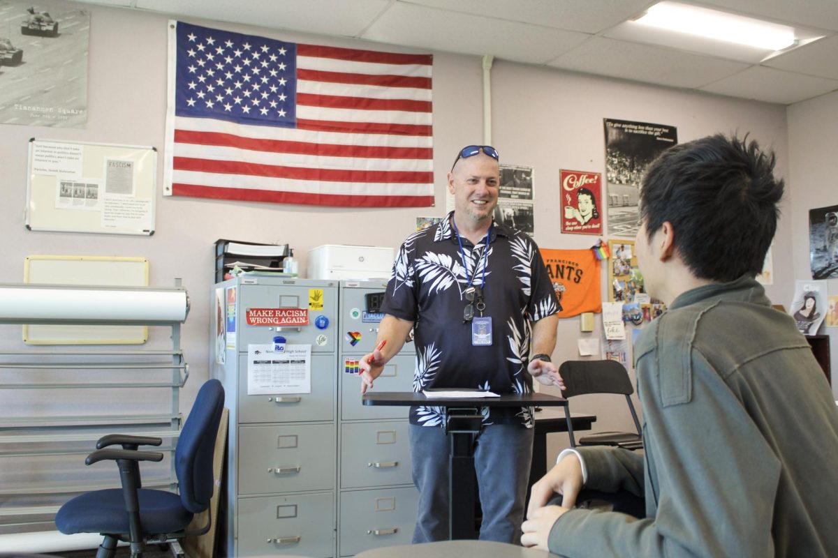 FOSTERING DIALOGUE: AP Government teacher Steven Plete engages with a student students 
