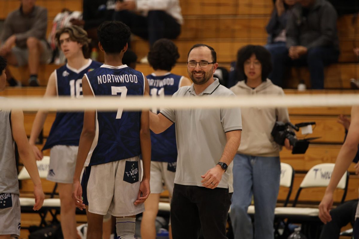 COACHING CHAMPIONS:  Boys volleyball head coach Brendan Geck encourages his players during  a home game.