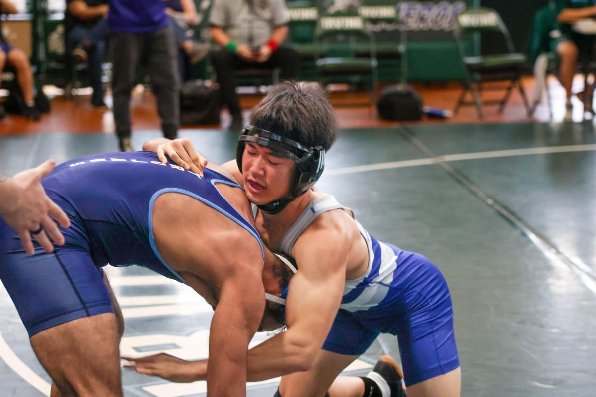 HEADLOCKED-IN:  Senior Elliott Son pins his opponent in Wrestling’s League Finals.