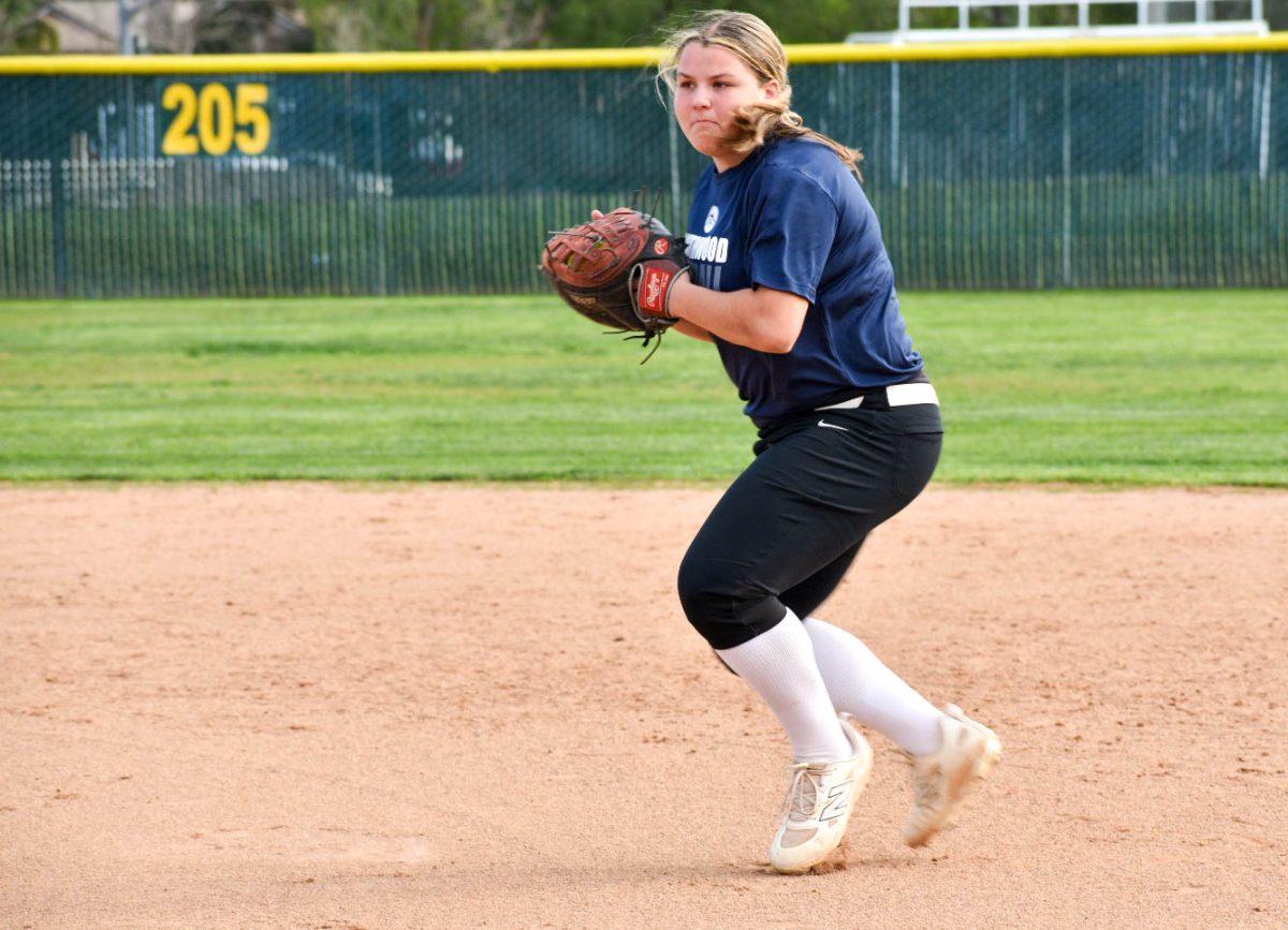 COMING IN FIRST: First baseman Katerinna Rizos prepares her throw to home base as she diligently trains for her upcoming game.