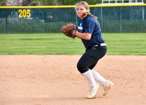 COMING IN FIRST: First baseman Katerinna Rizos prepares her throw to home base as she diligently trains for her upcoming game.