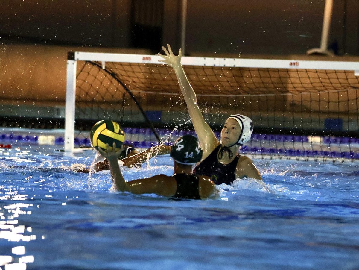 DEFEND THE DEN: Sophomore Cassidy McCallon guards the goal at a JV girls water polo away game.