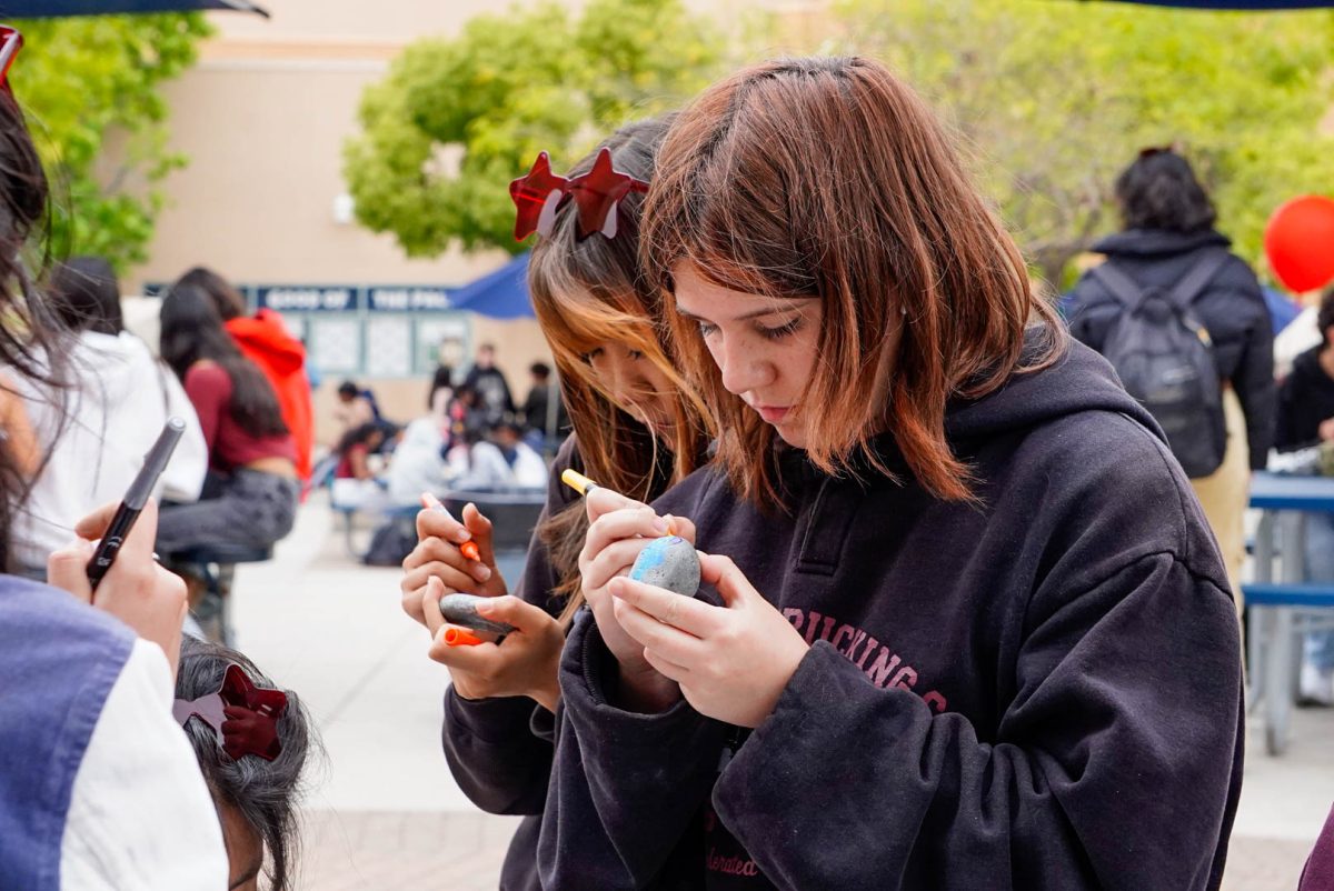 Mindful Moments: Freshman Raegan Ivanista focuses on decorating her rock with acrylic markers at the Oak during Sleep for Success Week.