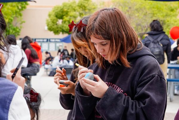 Mindful Moments: Freshman Raegan Ivanista focuses on decorating her rock with acrylic markers at the Oak during Sleep for Success Week.