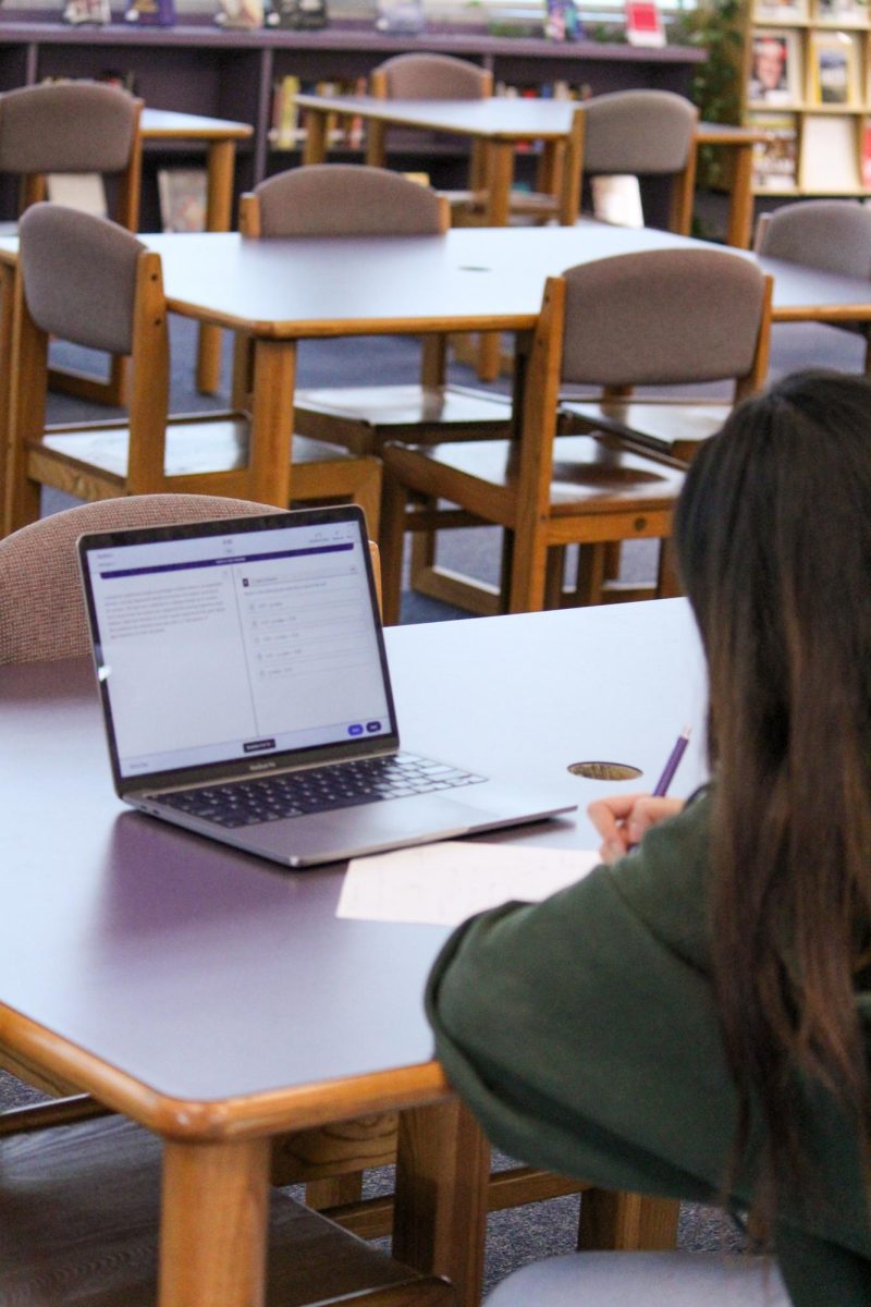 BOOKLETS AND BLUEBOOK: Senior Erica Zou takes a practice AP Statistics test on Bluebook using digital formula sheets and scratch paper. 