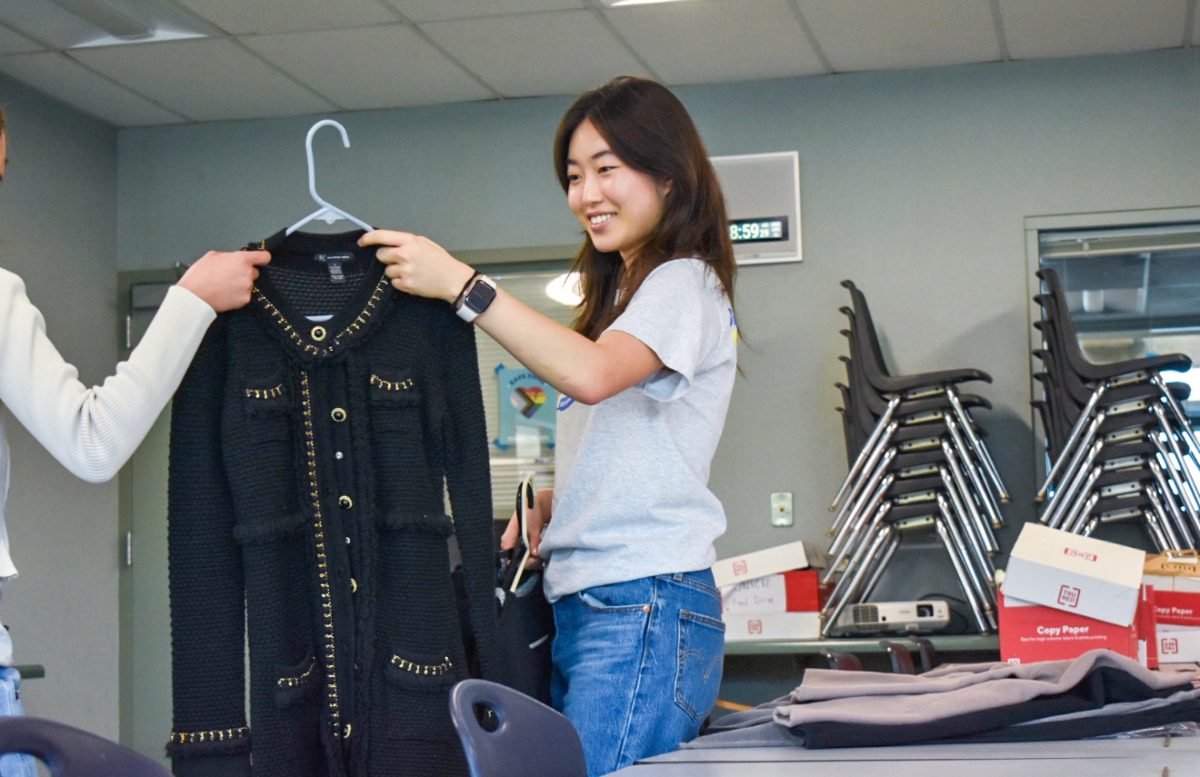 Senior and CSF Club President Hannah Cho receives formal apparel at the CSF donation drive, preparing to send the contribution to Working Wardrobes. 