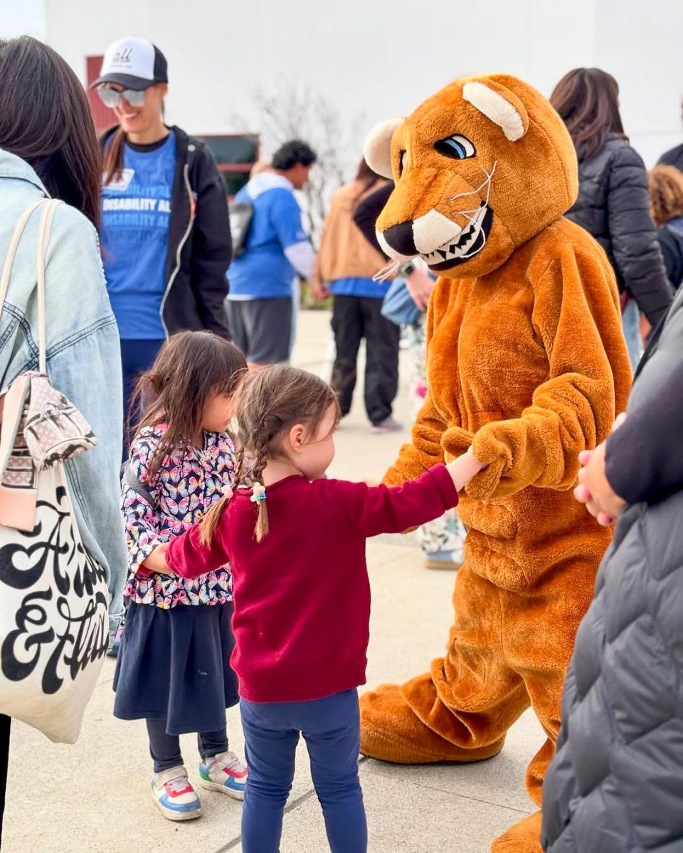 PAWS FOR INCLUSION: Two young attendees share a moment with the school mascot during Irvine’s Disability Awareness Day, highlighting the district’s ongoing efforts to foster belonging from the earliest years.
