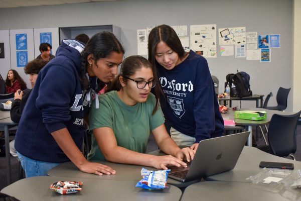 RADIANT ROBOTICS: Northwood Robotics Club President and Technodream 50881A Team Manager Jia Dave works alongside her fellow board members on their VEX robot, configuring the controller and debugging errors.