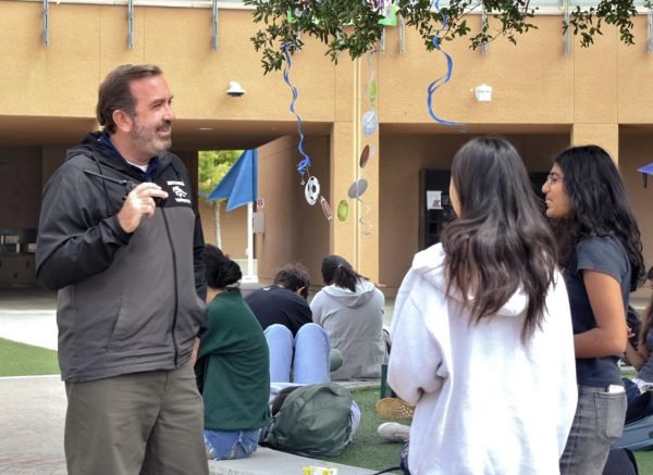 FUN WITH FACULTY: Assistant principal Eric Keith converses with sophomores Trisha Kolur and Grace Li during Advisement, discussing school life and weekend plans.