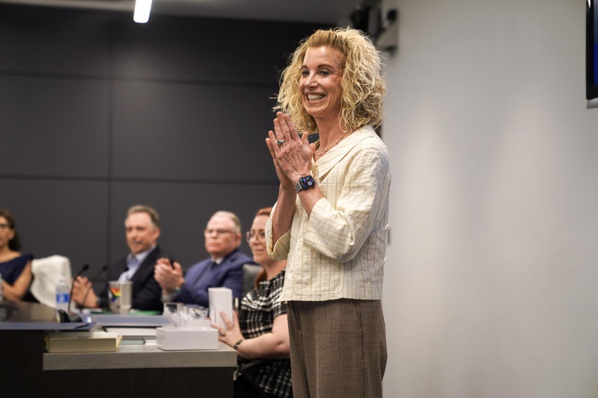 BACK IN THE BOARDROOM: At the IUSD Administration Center, Cassie Parham congratulates IUSD student board members during a Board of Education meeting. 