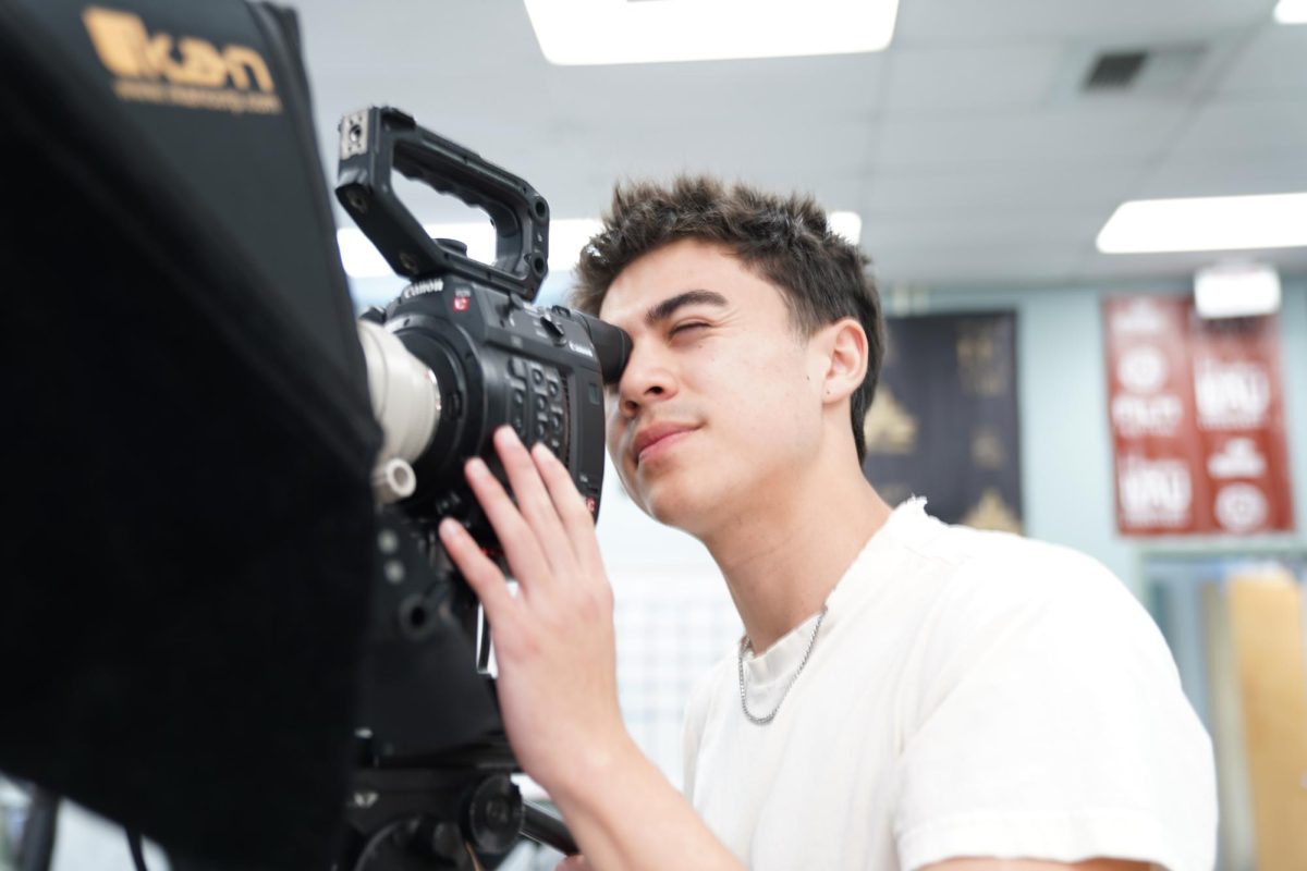 CRAFTING CINEMA: Senior Noah Villanueva frames the camera for an NTV shoot.