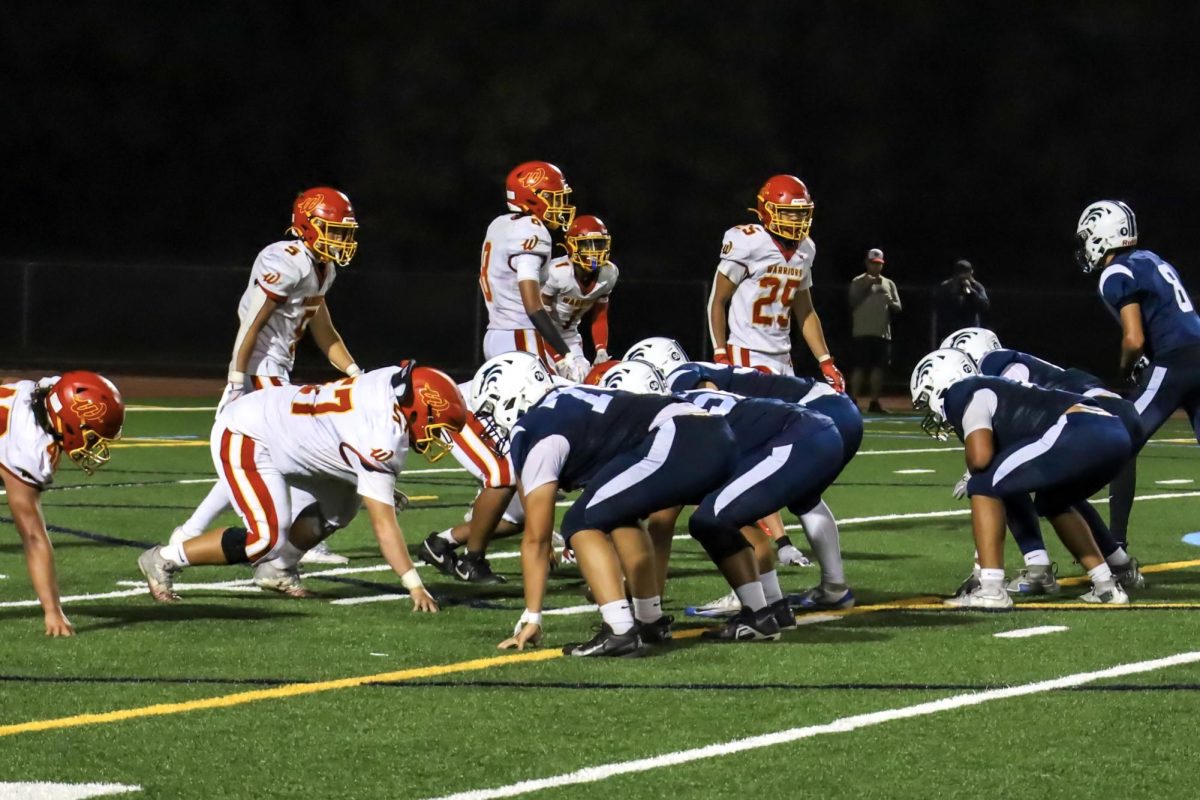 TOE TO TOE-CHDOWN: The Northwood football team prepares an offensive play against Woodbridge.