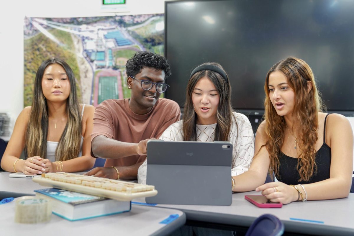 DRAFTING UP HYPE: Northwood’s ASB Executive Board rehearses and edits their script for the next pep rally during break.