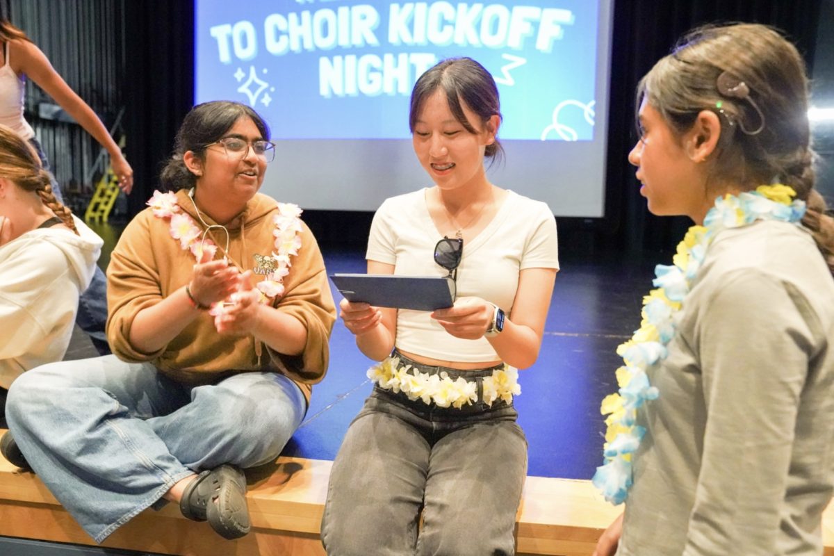 CHOR-US: Junior Sonia Khot and senior Minnie Chi explain choir to an underclassman at kickoff night.