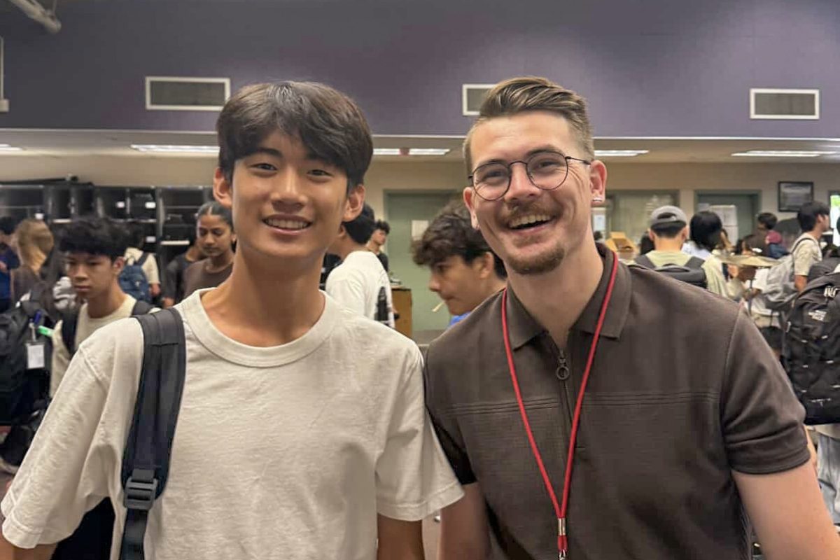 BAND-ING TOGETHER: Sophomore Alvin Chung and music director Cole Quizon pose after an eventful rehearsal.