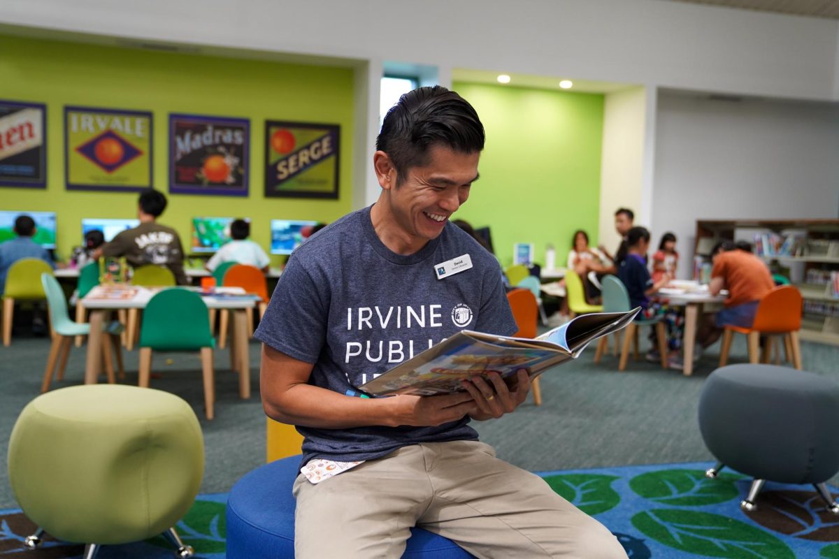 BOOKED FOR A BREAK: At Heritage Park Library, library branch supervisor David Cheung reads a book in order to unwind after a busy day. 