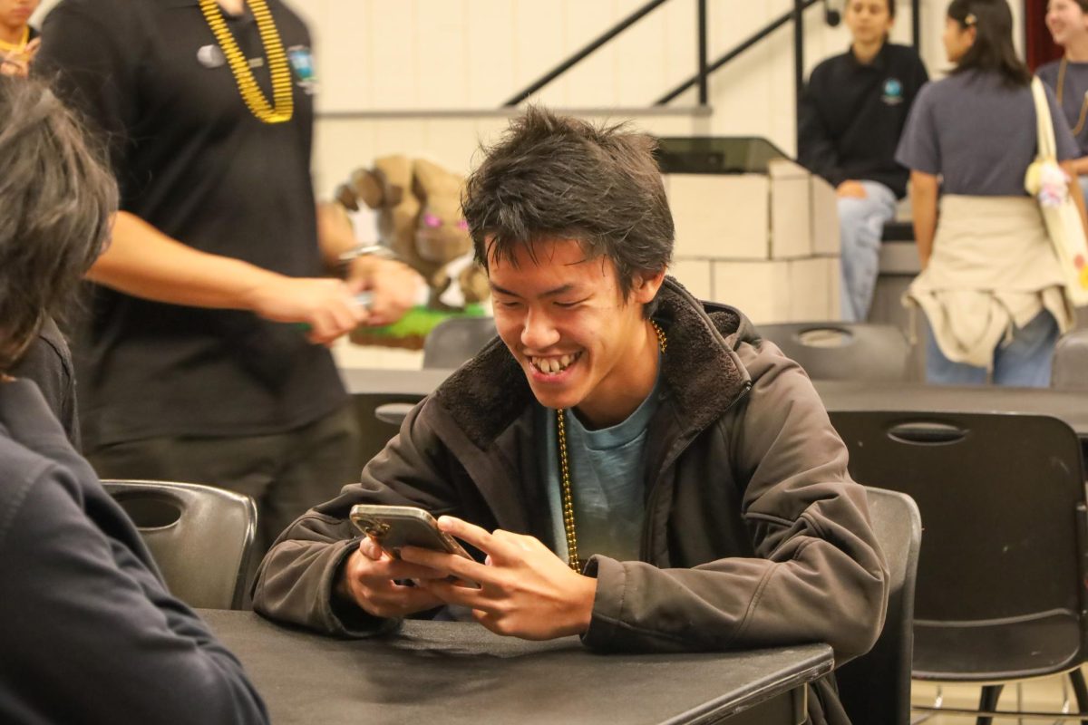 GAMING FOR GLORY: Junior Edon Deng celebrates a successful strategy against his second round opponent of the Clash Royale Tournament.