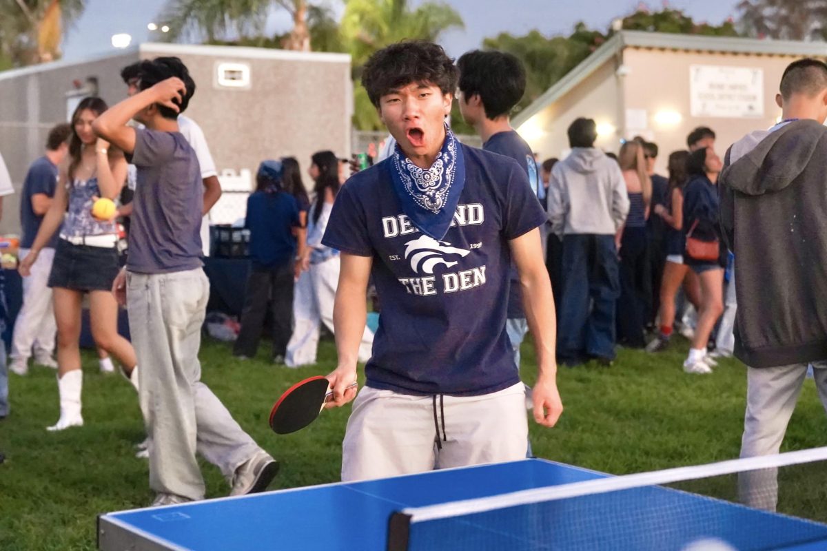 PING-PONG AND PLAY: At Northwood’s Homecoming Tailgate, senior Nathan How celebrates after winning a round of ping-pong.