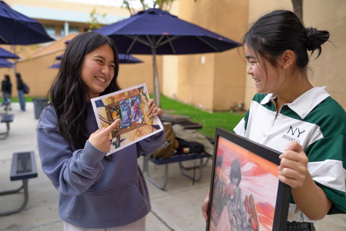 CREATIVITY MATTERS: Juniors Mia Chun and Jiyoung Yun smile as they share their artwork submissions for the #CreateConnectCare art contest, exchanging thoughts on each other’s pieces and embracing the spirit of vulnerability that the contest promotes.