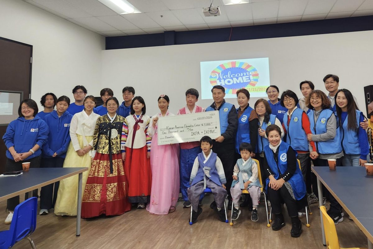 SEOLLAL WITH SENIORS: Lead volunteer sophomore Kailey Yoon and the Irvine Korean Parents Association Volunteer Committee make a donation to support the Korean American Dementia Center as they wish good health and happiness to all.