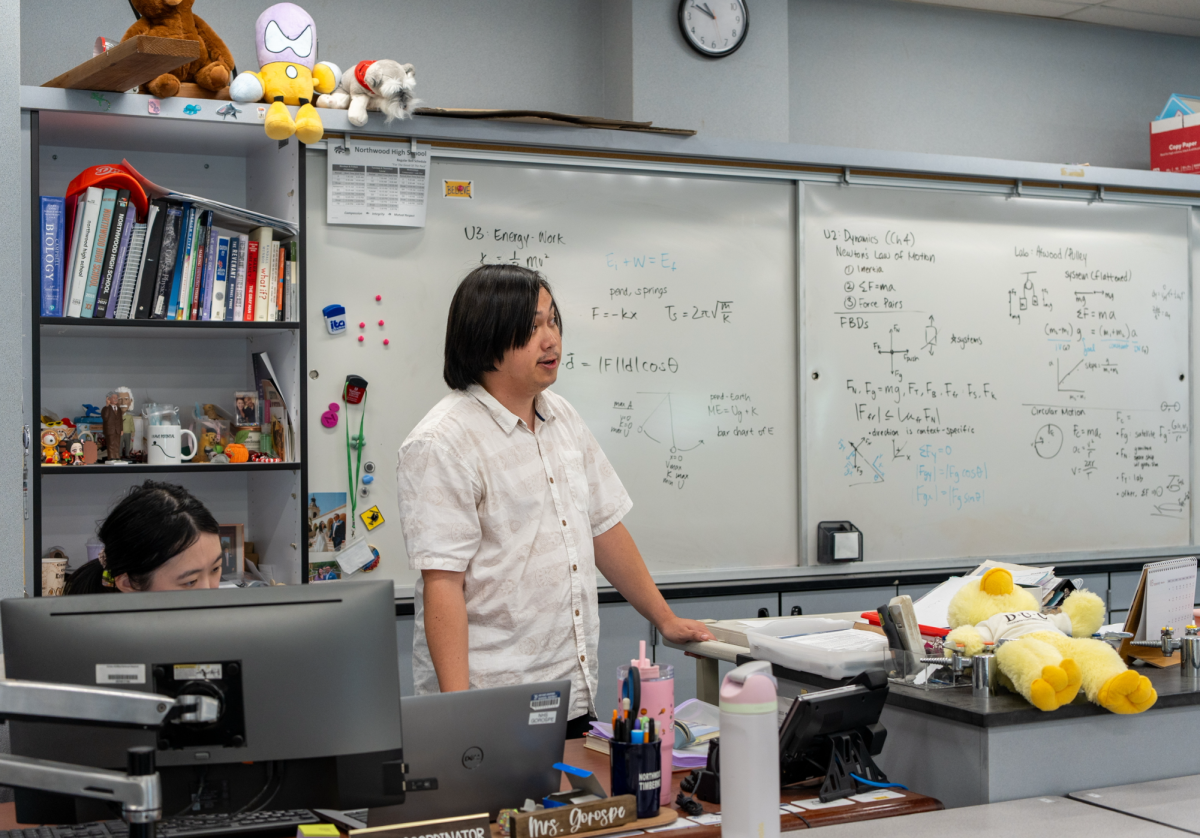 CLASSROOM SUPPORT: Student teacher Joseph Mackey guides students through science teacher Karen Gorospe’s Integrated Science 2 class.