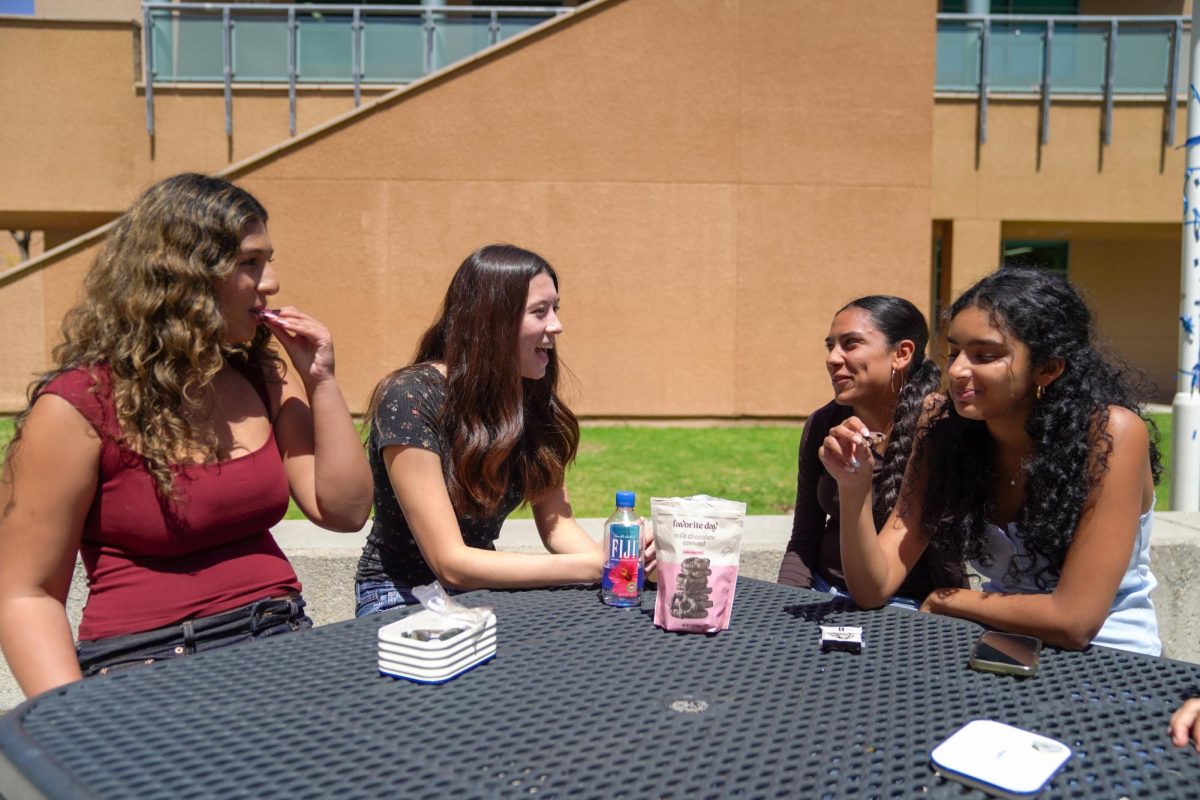 SWEET CONNECTION: Juniors Braelynn Lynch and Sejal Sachdeva chat while they snack on chocolate covered pretzels during lunch.